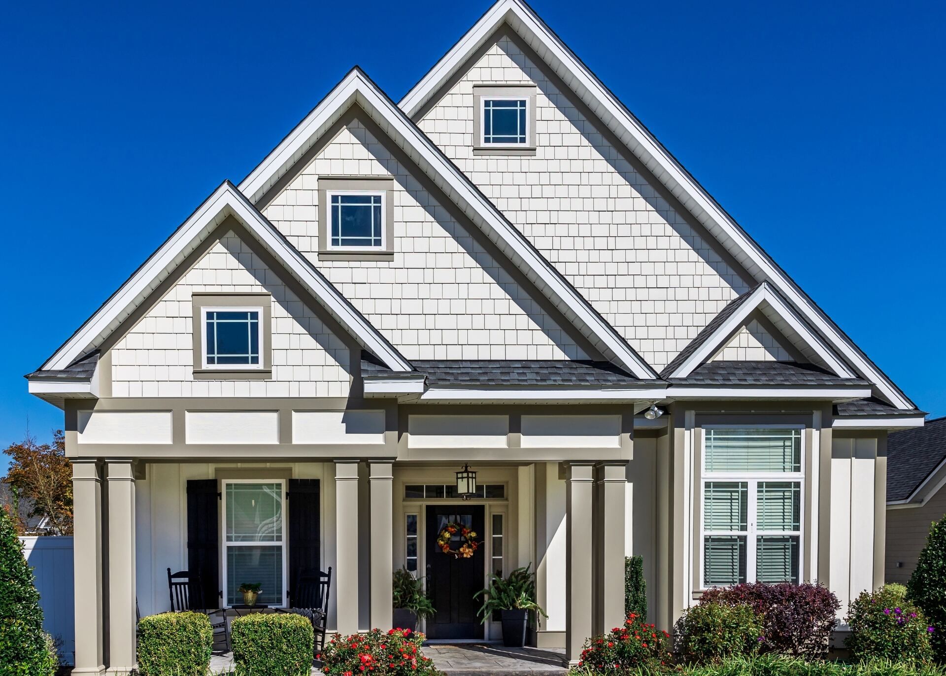 Exterior house painting project with crisp siding and updated curb appeal